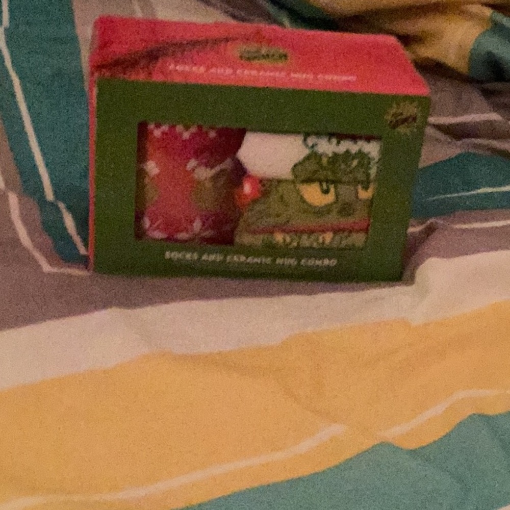 Hobby Lobby Green and Red Grinch mug and four pack of fuzzy socks